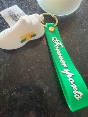 White Sneaker Keychain with Green Strap and Gold Ring